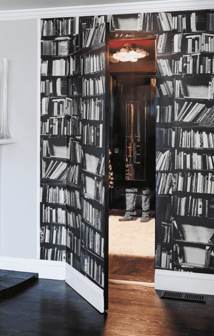 The door and part of the wall are decorated with a book print