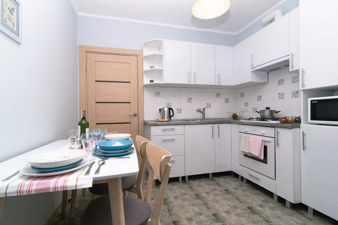 kitchen in white in a studio apartment