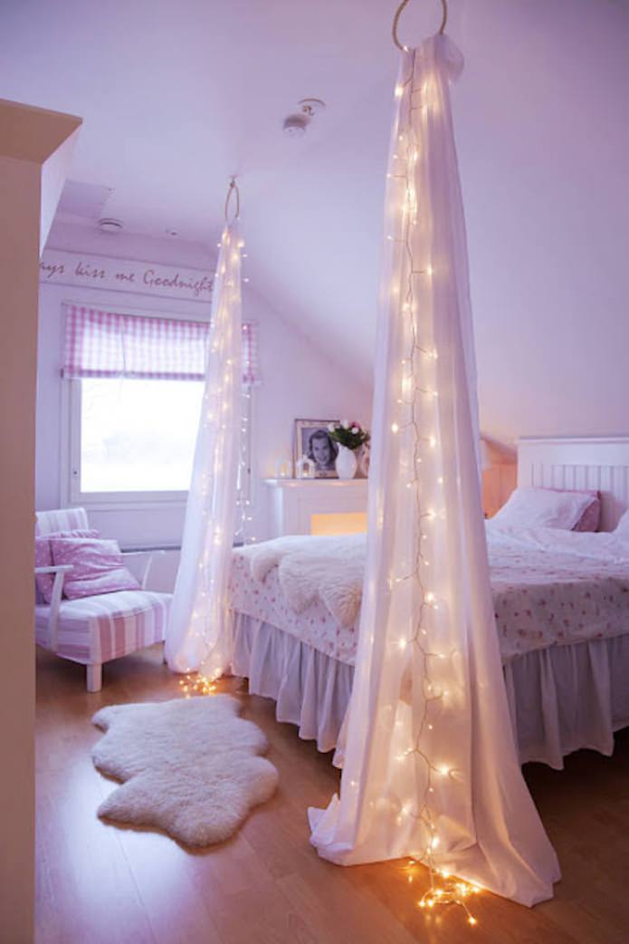 translucent fabric with garland by the bed