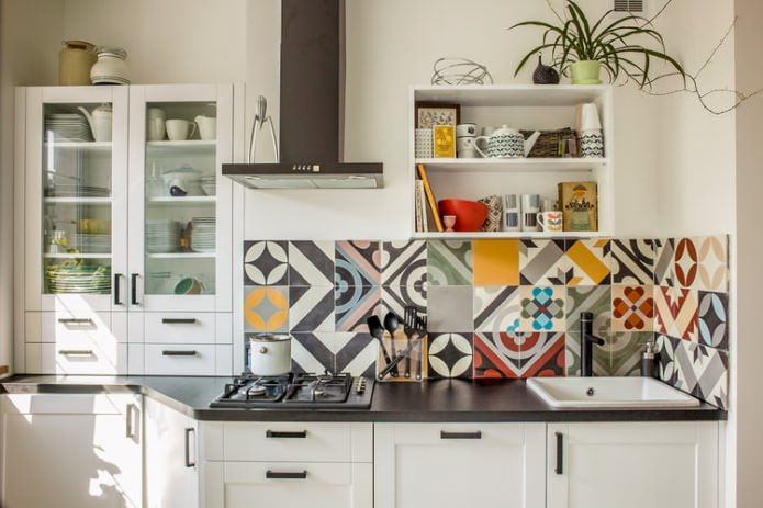 patchwork tiles on the backsplash in the kitchen
