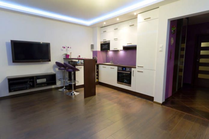 Kitchen-living room design with a bar counter in white and purple tones