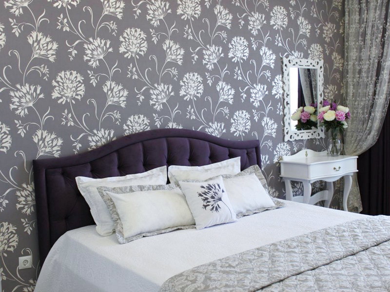 White floral patterns on gray wallpaper in the bedroom