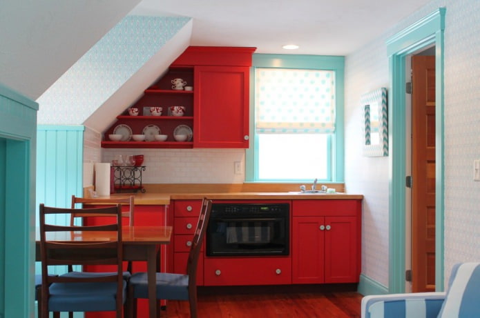 blue and white wallpaper in the kitchen with red facades