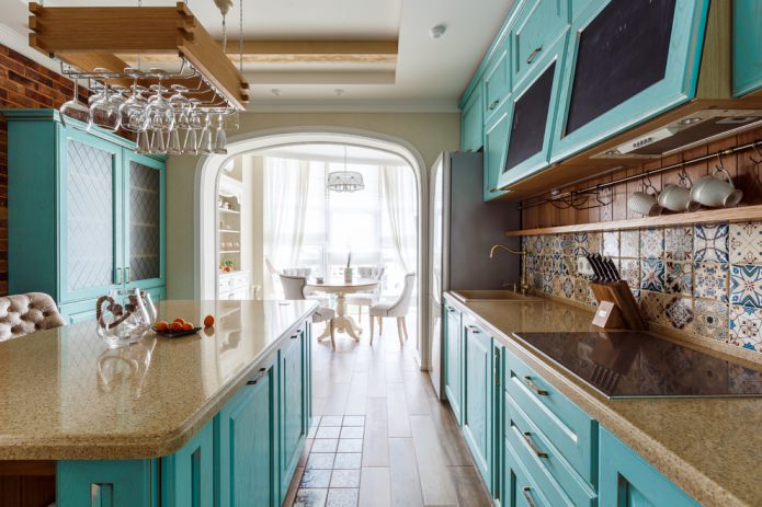 kitchen interior in turquoise color with majolica on a kitchen apron