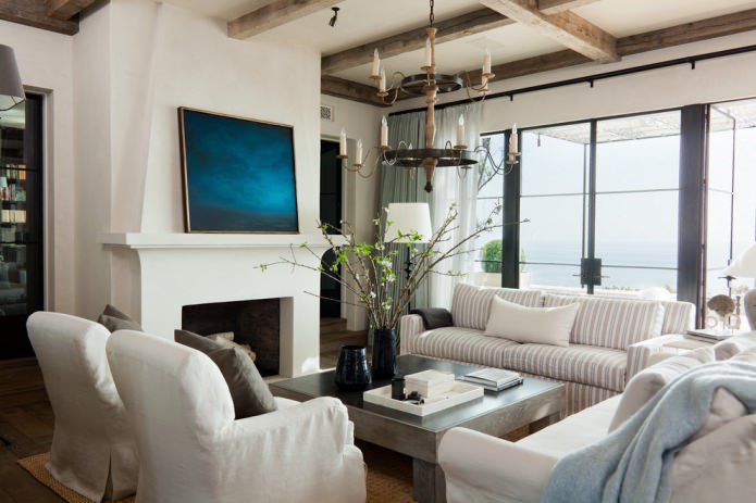 living room interior with decorative beams and forged hanging chandelier