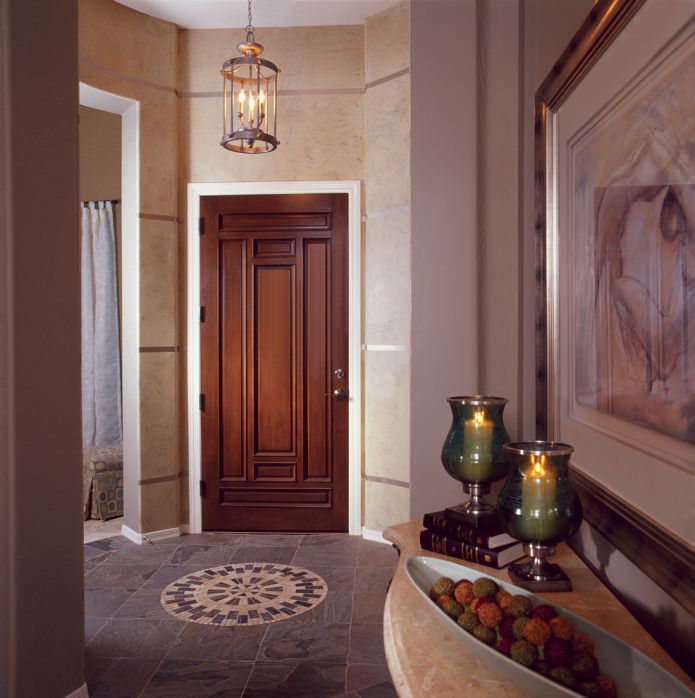 massive doors with a carved pattern in the interior of a classic hallway