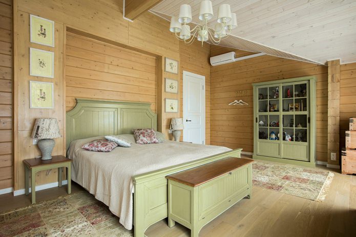 bed and wardrobe in light olive tones