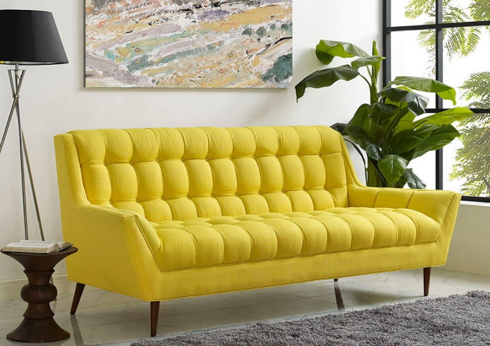 yellow sofa on legs in the interior