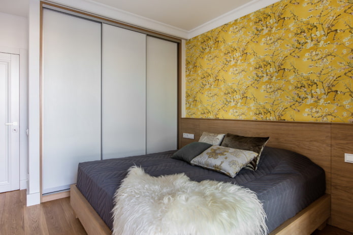 yellow accent wall in the bedroom