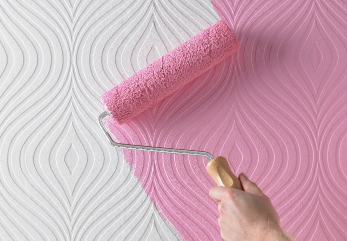 painting the wallpaper with a roller