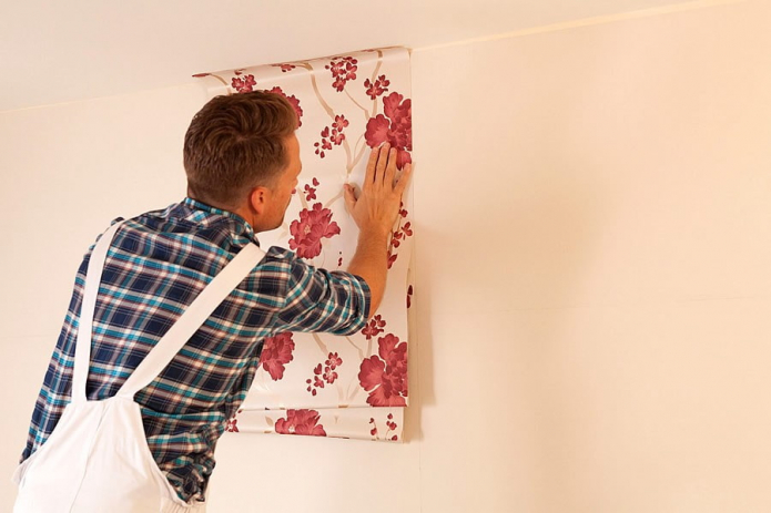 gluing wallpaper on the walls