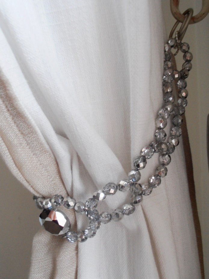 curtain with a tie-back made of jewelry