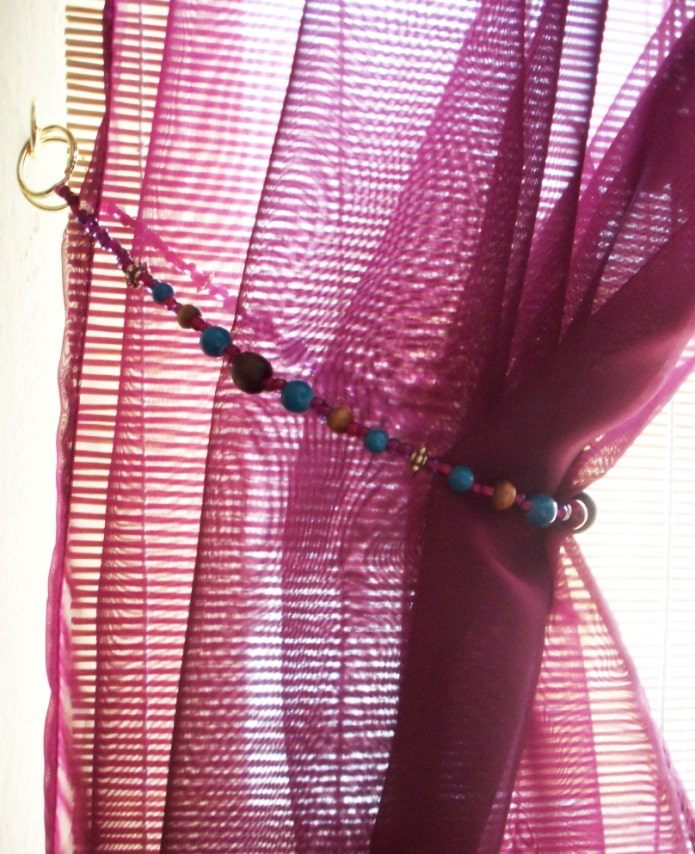 curtain with a tie-back made of jewelry