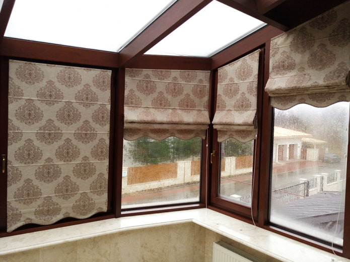Roman blinds with monograms on the loggia
