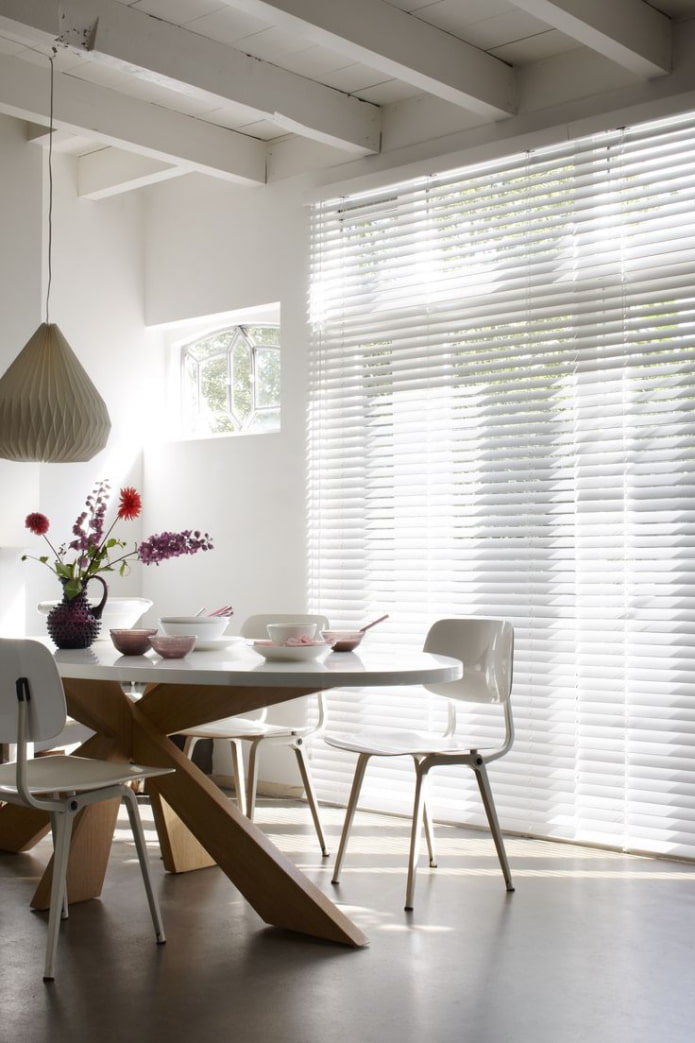 white horizontal blinds in the dining room
