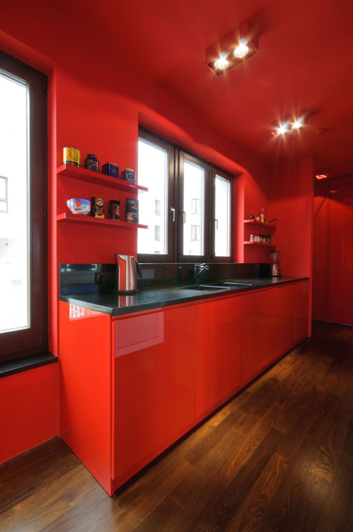 completely red kitchen with wood floor