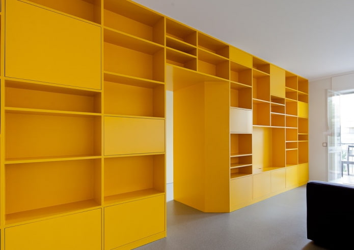 yellow wardrobe in the form of a partition in the interior