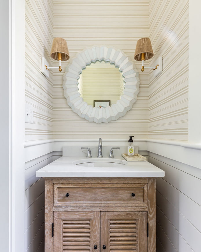 mirror with sconces in the interior of the bathroom