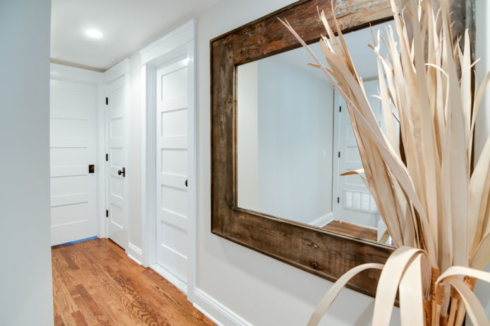 mirror in a wooden frame in the interior of the hallway