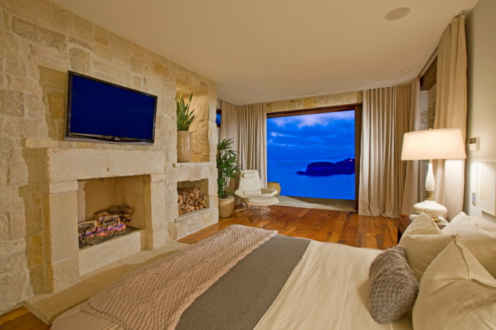 TV in the interior of the bedroom with a fireplace