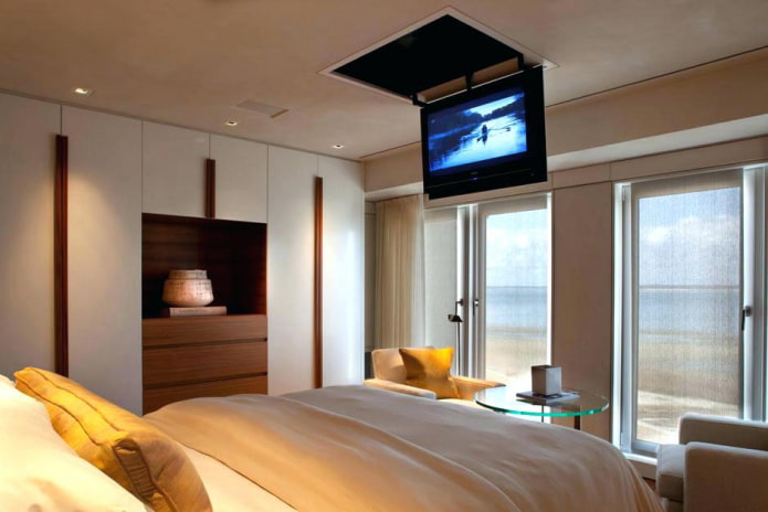 TV on the ceiling in the interior of the bedroom