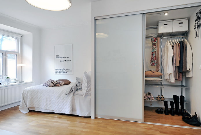 dressing room with glossy doors in the bedroom interior