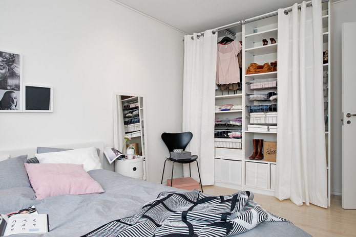 small bedroom with dressing room behind curtains