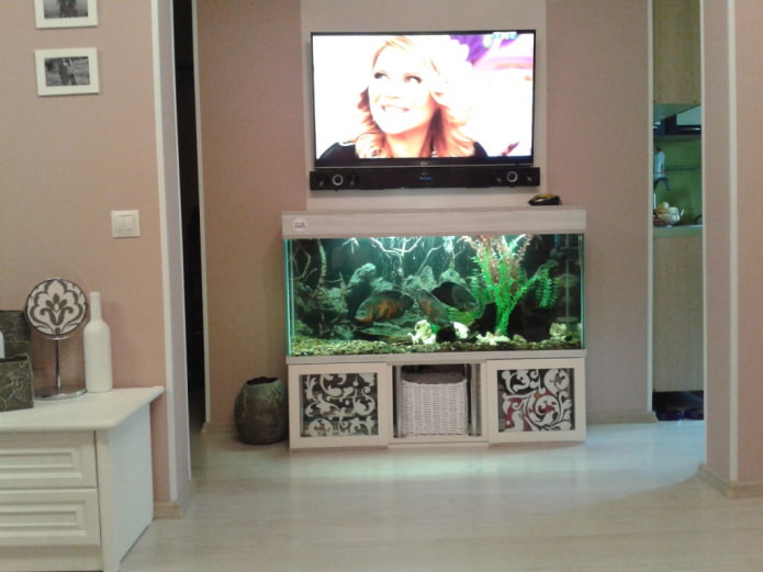 wall-mounted TV with an aquarium in the interior