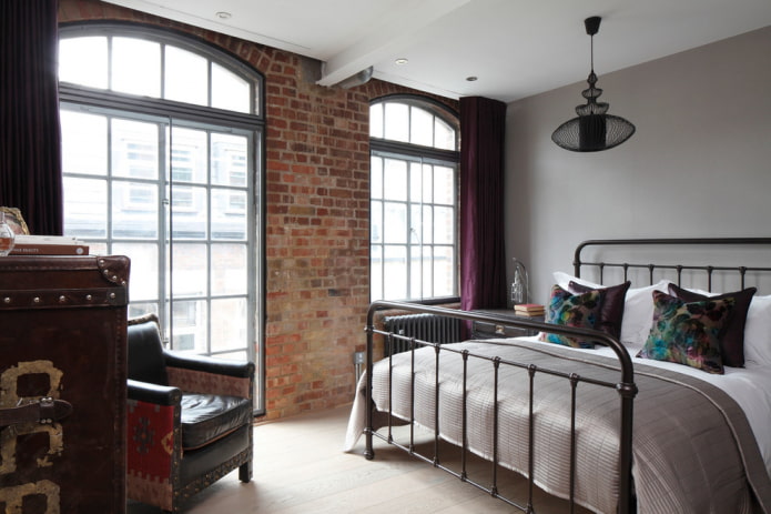 bed with wrought iron in the bedroom in the loft style