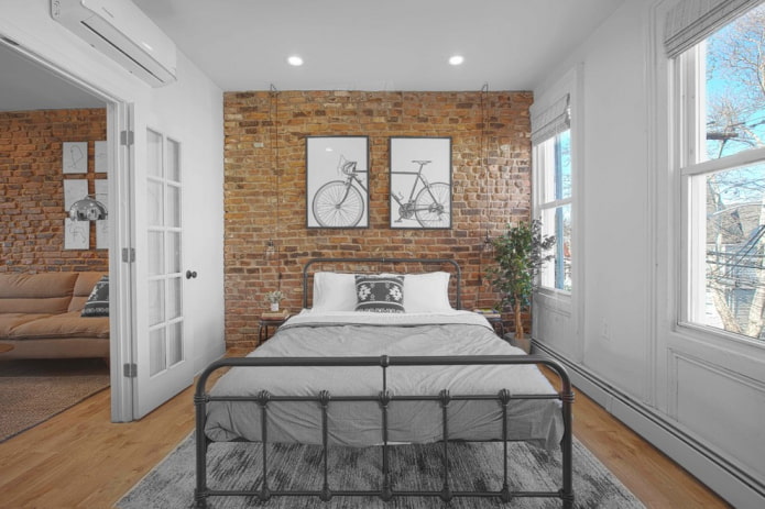 bed with wrought iron in the bedroom in the loft style