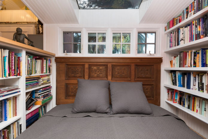 bed surrounded by books