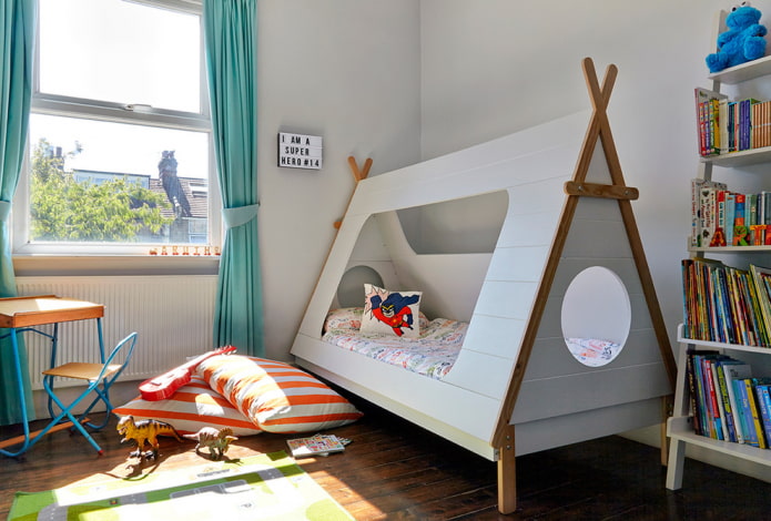 bed in the form of a wigwam in the nursery for a boy