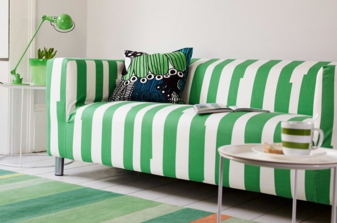 sofa with green upholstery in stripes in the interior