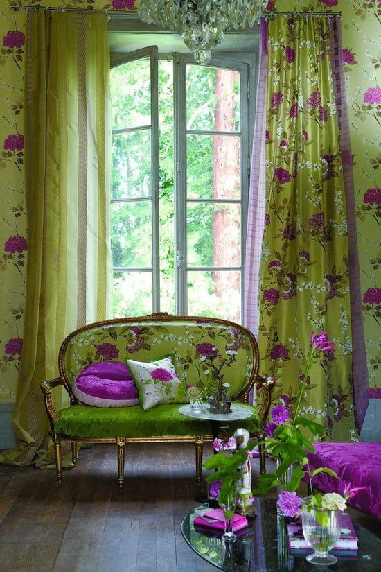 sofa upholstered in green with flowers in the interior