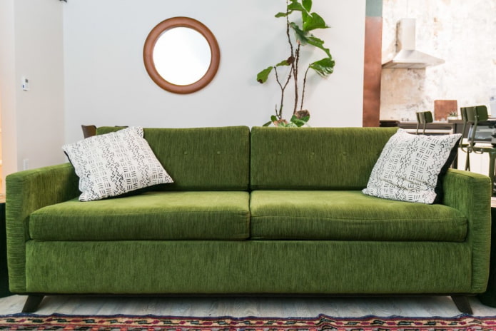 sofa with green fabric upholstery in the interior