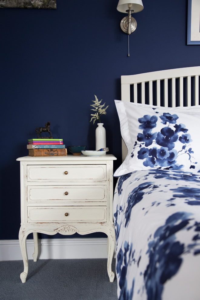 White bedside table on blue background