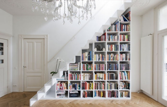 bookcase under the flight of stairs in the interior
