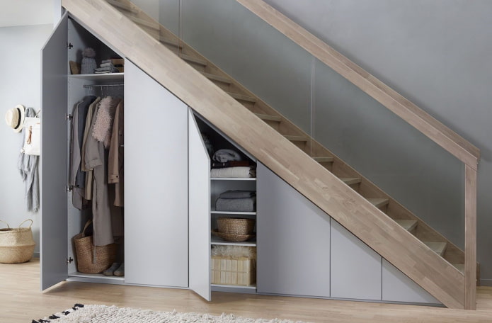 wardrobe with hinged doors under the flight of stairs