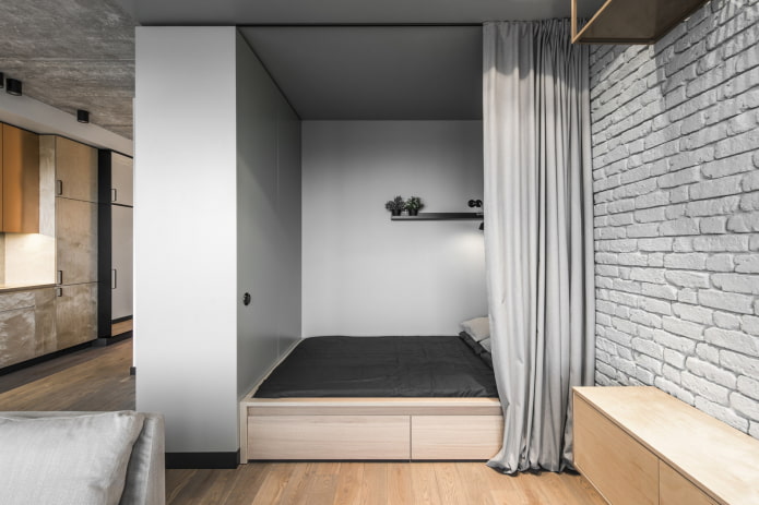 sleeping area in the interior of a studio apartment
