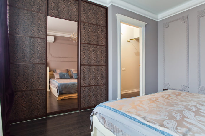 sliding wardrobe with leather facade trim in the bedroom