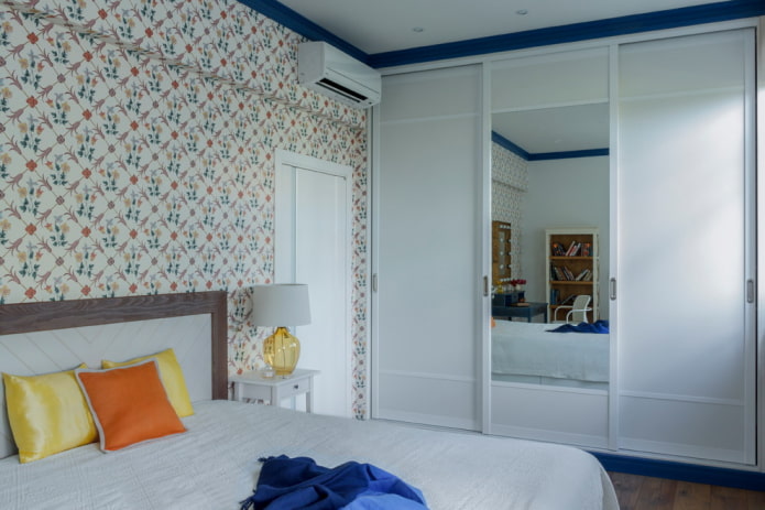 sliding wardrobe with a mirrored facade in the interior of the bedroom
