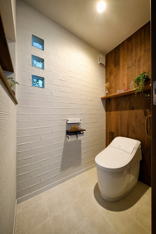 White toilet with a wooden false wall