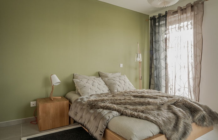 curtains in the interior of the bedroom in green tones