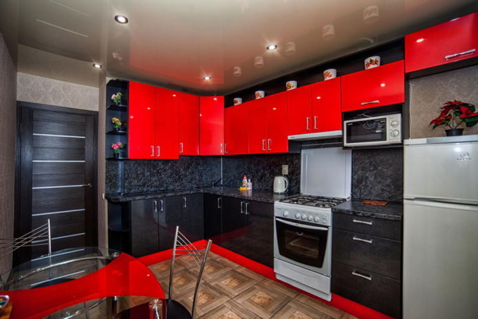 Red and black kitchen with dark door