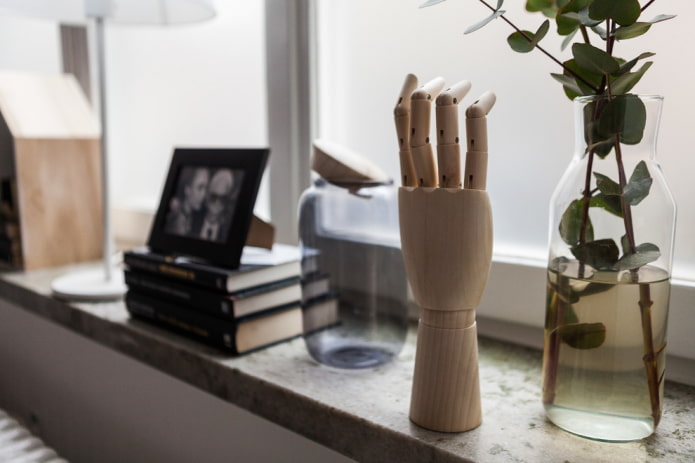 Hand figurine, books and vases