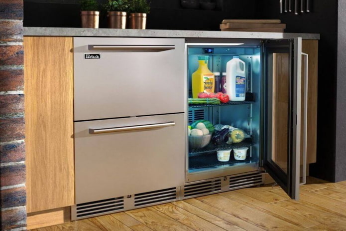 refrigerator under the countertop in the interior of the kitchen