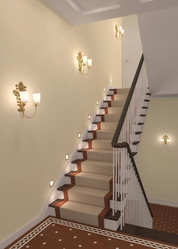 staircase with wall sconces in the interior of the house