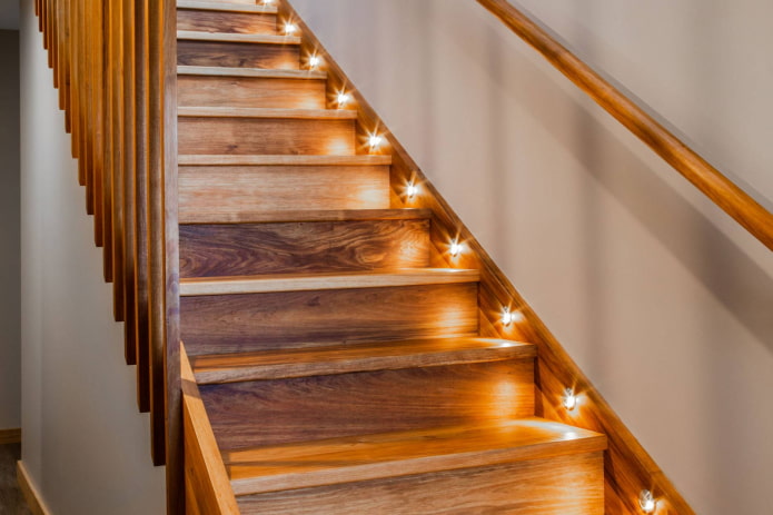 illuminated wooden staircase in the interior of the house