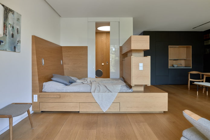 bed on the podium in a studio apartment