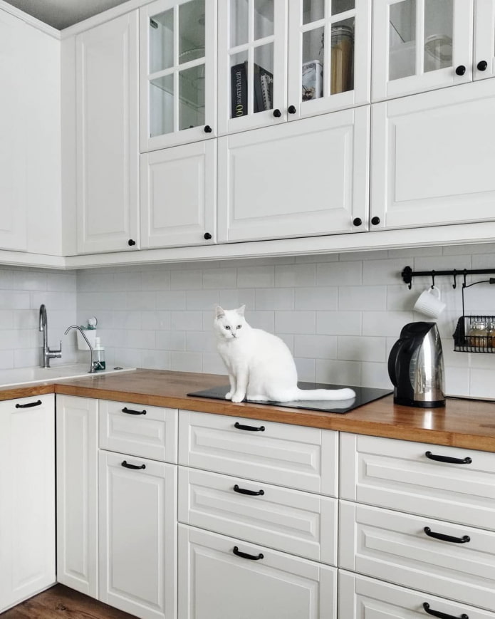 white kitchen with black handles